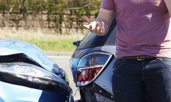 Car collision and man on phone annoyed