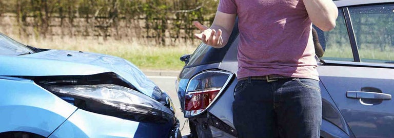 Car collision and man on phone annoyed