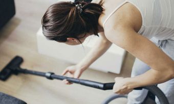 Women vacuuming floor