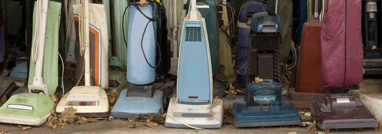 Old Vacuum Cleaners Lined Up in a row