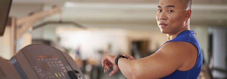 Man looking at watch at the gym