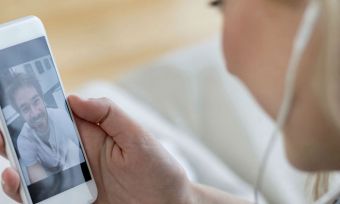 Women facetiming man with headphones