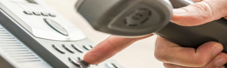 Person using landline to make call
