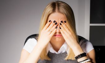 Women with hands on face with laptop