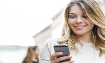 happy women looking at her phone