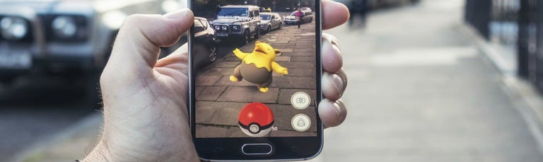 Person playing pokemon go in street