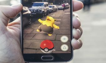 Person playing pokemon go in street