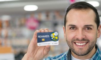 Man holding up loyalty program card