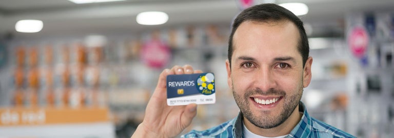 Man holding up loyalty program card