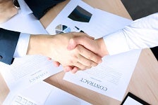 Firm handshake between two colleagues after signing a contract