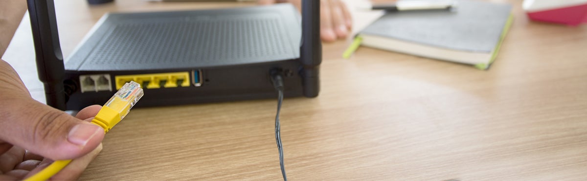 Modem or router hand plugging in router