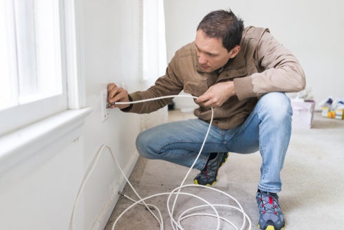 Young man installing television cable internet