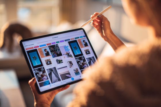 close up of person using tablet with a stylus