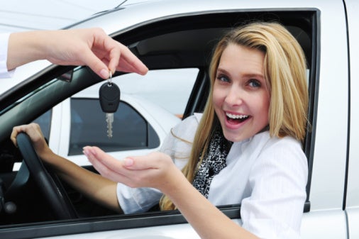 Woman receiving car keys